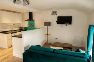 a living room with a couch and a kitchen at Victoria Street Apartments in Morecambe