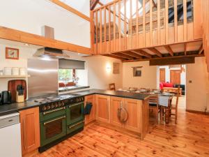 a large kitchen with a green stove top oven at Y Felin in Haverfordwest