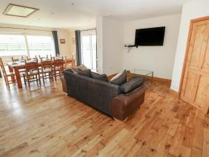 a living room with a couch and a table at Ty Mawr in Haverfordwest