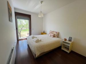 a small bedroom with a bed and a window at Villa Martins in Lagoaça +24 photos