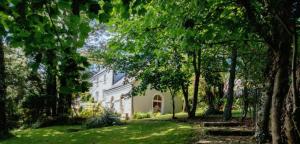 a white house with trees in front of it at Barnabrow Country House in Killinagh