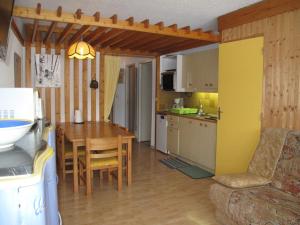 a kitchen and living room with a table and a dining room at Appartement Villard-de-Lans, 2 pièces, 6 personnes - FR-1-515-29 in Villard-de-Lans