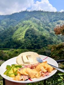 a plate of food on a table in front of a mountain at SAN FELIPE CASA QUINTA in Ibagué