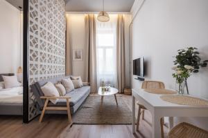 a living room with a couch and a table at A62 - Akácfa Street Central Residence - Best Location by BQA in Budapest