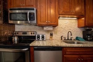 a kitchen with a stove microwave and a sink at Beaver Village Unit #0211 in Winter Park +24 photos