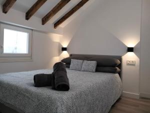 a white bedroom with a large bed in a room at Gran Via 16 Bilbao centro LBI00574 in Bilbao