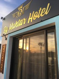 By Muhtar Hotel Bodrum في بودروم: مبنى فيه لافته على مليون فندق