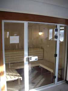 a glass door with a bench in a room at Meadowridge Court 19 Unit 1 in Fraser