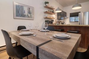 a dining room table with glasses and plates on it at Beaver Village Unit #0332 in Winter Park