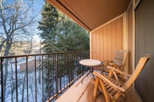 a balcony with a table and two chairs on it at Beaver Village Unit #0332 in Winter Park