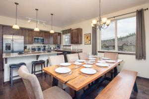 a kitchen and dining room with a wooden table and chairs at Trailhead Lodges Building 101 Unit 131 in Winter Park +23 photos