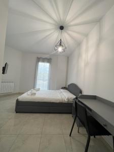 a bedroom with a bed and a table in it at Casa Vacanze Le Tre Scimmiette in Paterno