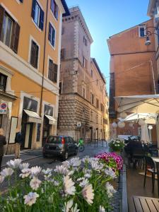 a street with buildings and flowers in a city at The Rabbit Hole in Rome