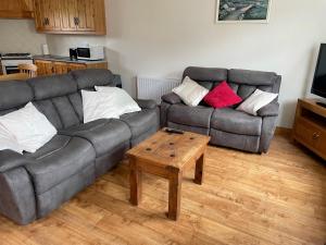 a living room with two couches and a coffee table at Hillside House - Ringfort in Ballinamuck