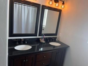 a bathroom with two sinks and a mirror at Compass Rose Colorado in Pagosa Springs