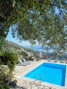 a swimming pool with a view of a resort at Villa Chrysoula in Kalami
