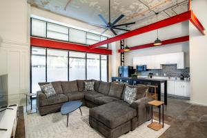 a living room with a couch and a table at Historic Downtown Loft with Modern Flare in Knoxville