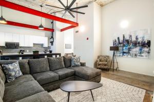 a living room with a couch and a table at Historic Downtown Loft with Modern Flare in Knoxville
