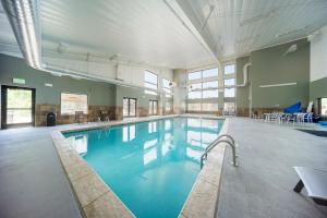 a large swimming pool with blue water in a building at Hi Country Haus Unit 1913 in Winter Park