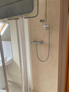 a shower with a shower head in a bathroom at Hillside House - Ringfort in Ballinamuck