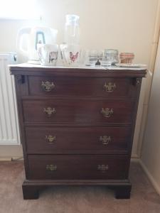 a wooden dresser with bowls on top of it at Cotswold Cottage Bed & Breakfast in Luckington