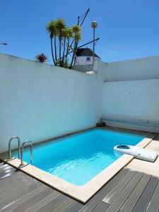 a swimming pool on top of a building at Sunset Street Beach house in Lourinhã