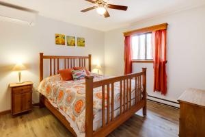 a bedroom with a bed and a ceiling fan at Spacious Pocono Lake House Near Skiing and Swimming! in Pocono Lake