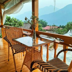 a table and chairs on a balcony with a view at Sapa Shalom Homestay in Sa Pa