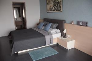 a rendering of a bedroom with a bed and a rug at Panorama Apartman in Velence