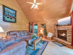 a living room with a couch and a fireplace at Idle Days, 2 Bedrooms, Sleeps 8, Pool Table, Grill, Pool Access, WiFi in Gatlinburg