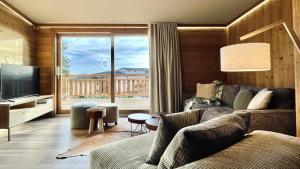 a living room with a couch and a large window at Chalet Snö 1750 in Font Romeu Odeillo Via