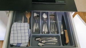 a drawer filled with utensils in a kitchen at Studio Bufnița - The Owl's Nest in Sibiu