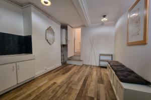 a living room with a couch and a hallway at La Cabane de Milo - Typical Honfleur fisherman's house - 2 bedrooms in Honfleur +15 photos