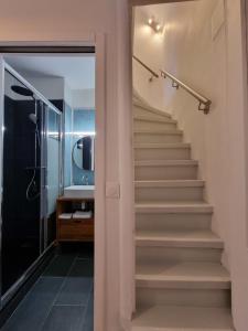 a staircase in a bathroom with a shower and a sink at La Cabane de Milo - Typical Honfleur fisherman's house - 2 bedrooms in Honfleur