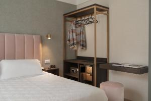 a bedroom with a white bed and a closet at Hotel Sole in Riccione