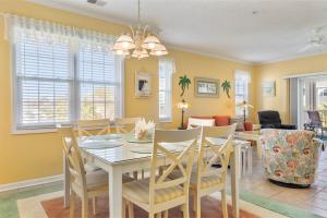 a dining room and living room with a table and chairs at NEW! Gated Community, Pools, Gym, Beach @ Ocean Keyes #1721 in Myrtle Beach