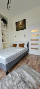 a bedroom with a large bed and a rug at Apartament 39 in Lublin