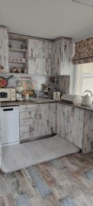 a kitchen with wooden cabinets and a white refrigerator at Kiki Home in Blagoevgrad