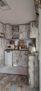 a kitchen with wooden walls and white appliances at Kiki Home in Blagoevgrad