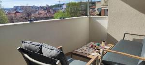 a small balcony with two chairs and a table and a window at Kiki Home in Blagoevgrad +7 photos
