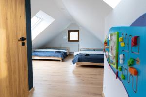 a bedroom with two beds in a attic at Chalupa Martinček in Terchová +62 photos