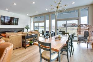 a dining room and living room with a table and chairs at Waterfront Watertown Condo with Patio and Pool Access! in Watertown