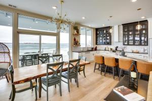 a kitchen and dining room with a table and chairs at Waterfront Watertown Condo with Patio and Pool Access! in Watertown