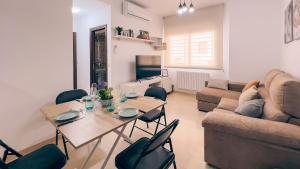 a living room with a table and chairs and a couch at Casa Yaye Écija in Écija