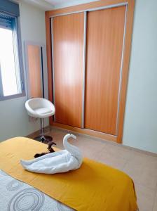 a swan decoration sitting on a bed in a room at Luz de Mar. in Carboneras