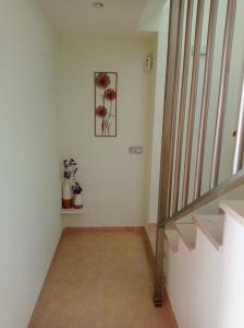 a hallway with stairs and a picture of flowers on the wall at Luz de Mar. in Carboneras