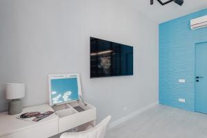 a room with a desk with a mirror and a blue door at THE BEST APARTMENT ON THE SEASIDE IN ODESA! Luxury apartments in Arcadia, near seaside! in Odesa