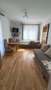 a living room with a couch and a table at Marszałek Mielno in Mielno