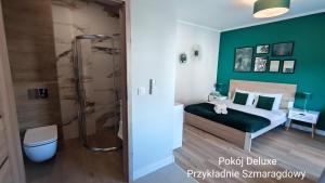 a bathroom with a bed and a shower in a room at BALTICUS Mrzeżyno in Mrzeżyno