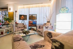 a living room with couches and a table at Hotel iDesign in San Marino